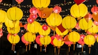 A festive evening scene with lanterns casting warm light over a table set for Eid celebration.