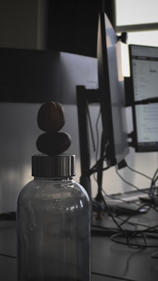 A Mendon Springs bottle sitting on a desk next to a laptop and notebook.