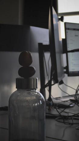 Close-up of a Mindfuel bottle with a blurred background of a busy office environment.