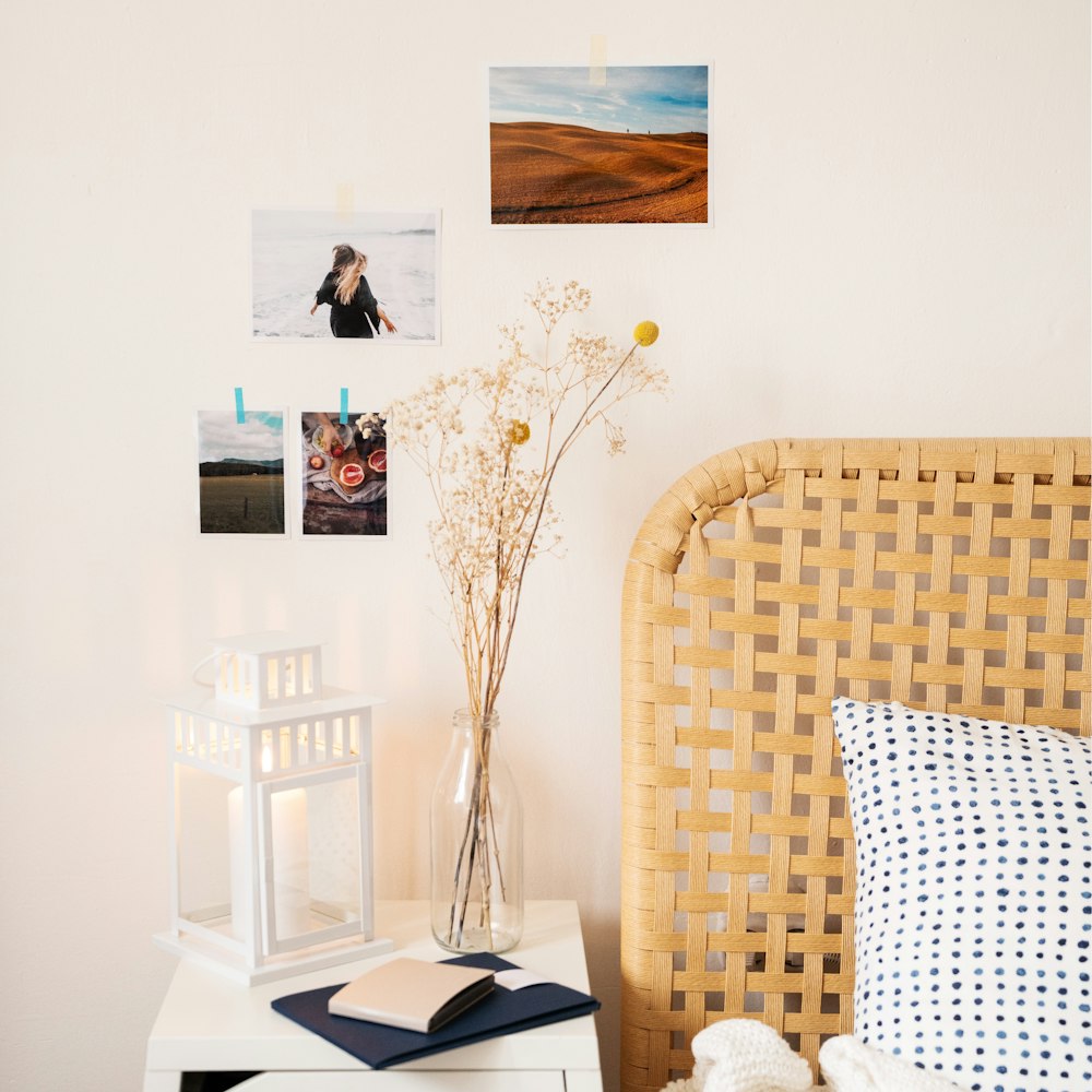 a wicker headboard with a vase of flowers on top of it