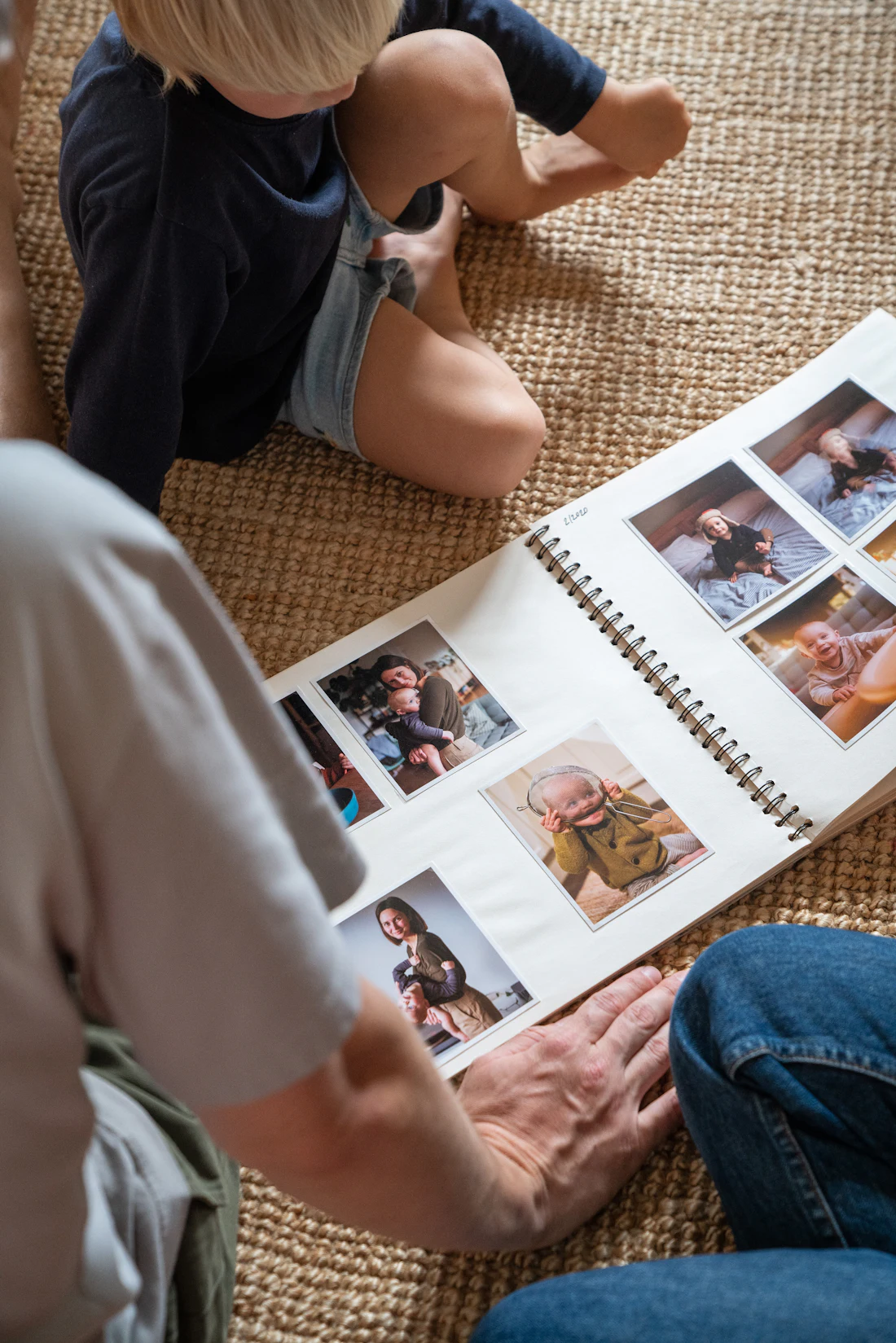 Hands turning pages in a printed family photo album
