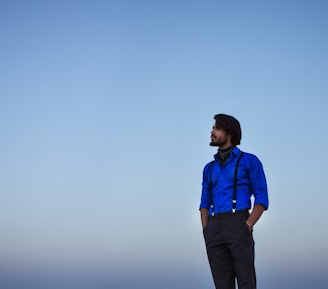 A mature man standing strong at sunrise, looking towards a new horizon.