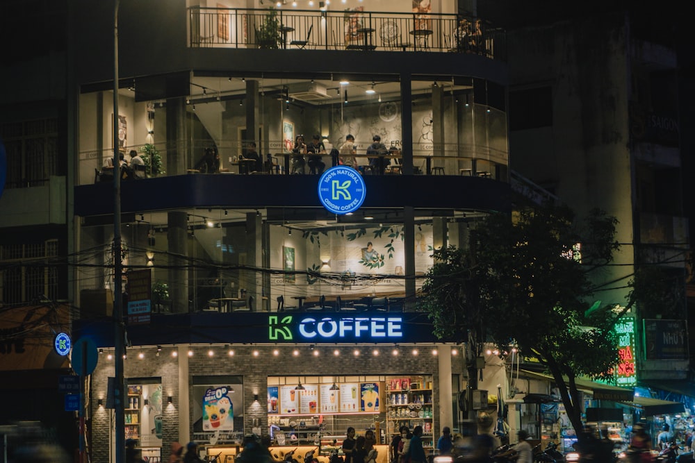 a group of people standing outside of a building at night