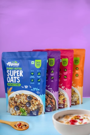 five bags of cereal sitting next to a bowl of cereal