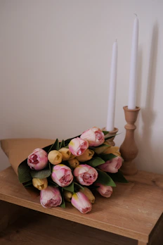 Elegant arrangement of colorful tulips placed on a rustic wooden table
