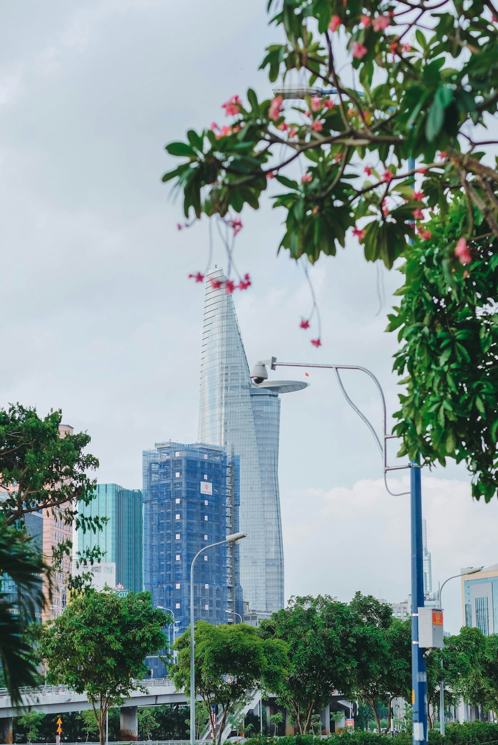 a city street with a tall building in the background