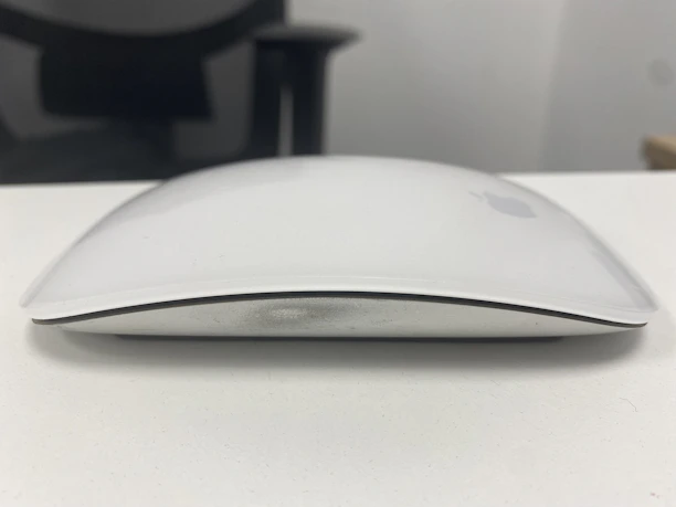 Close-up shot of a stylish Microsoft mouse resting on a minimalist white desk.