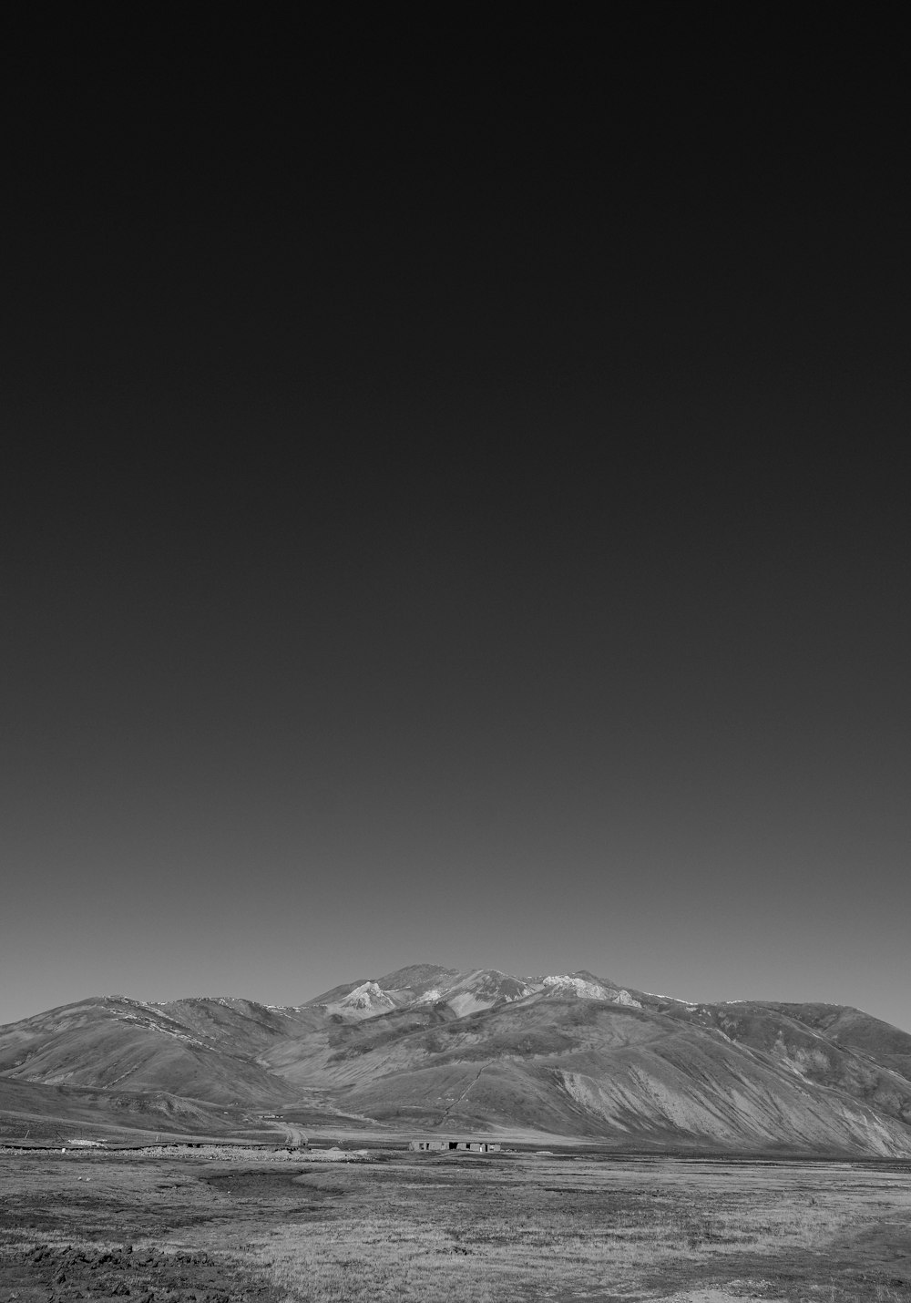 a black and white photo of a mountain range