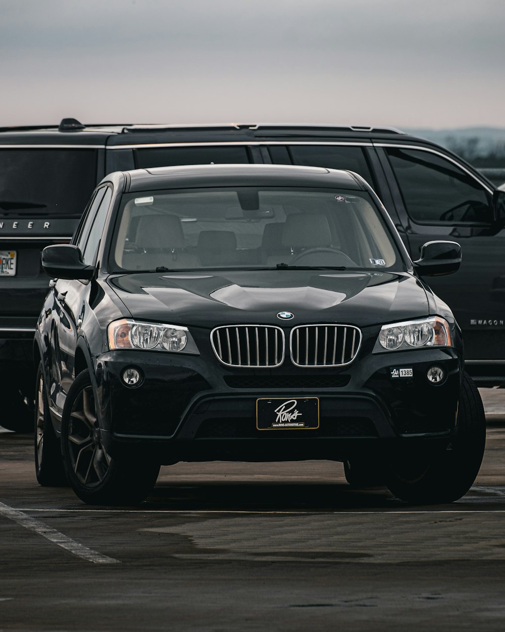 a black car is parked in a parking lot