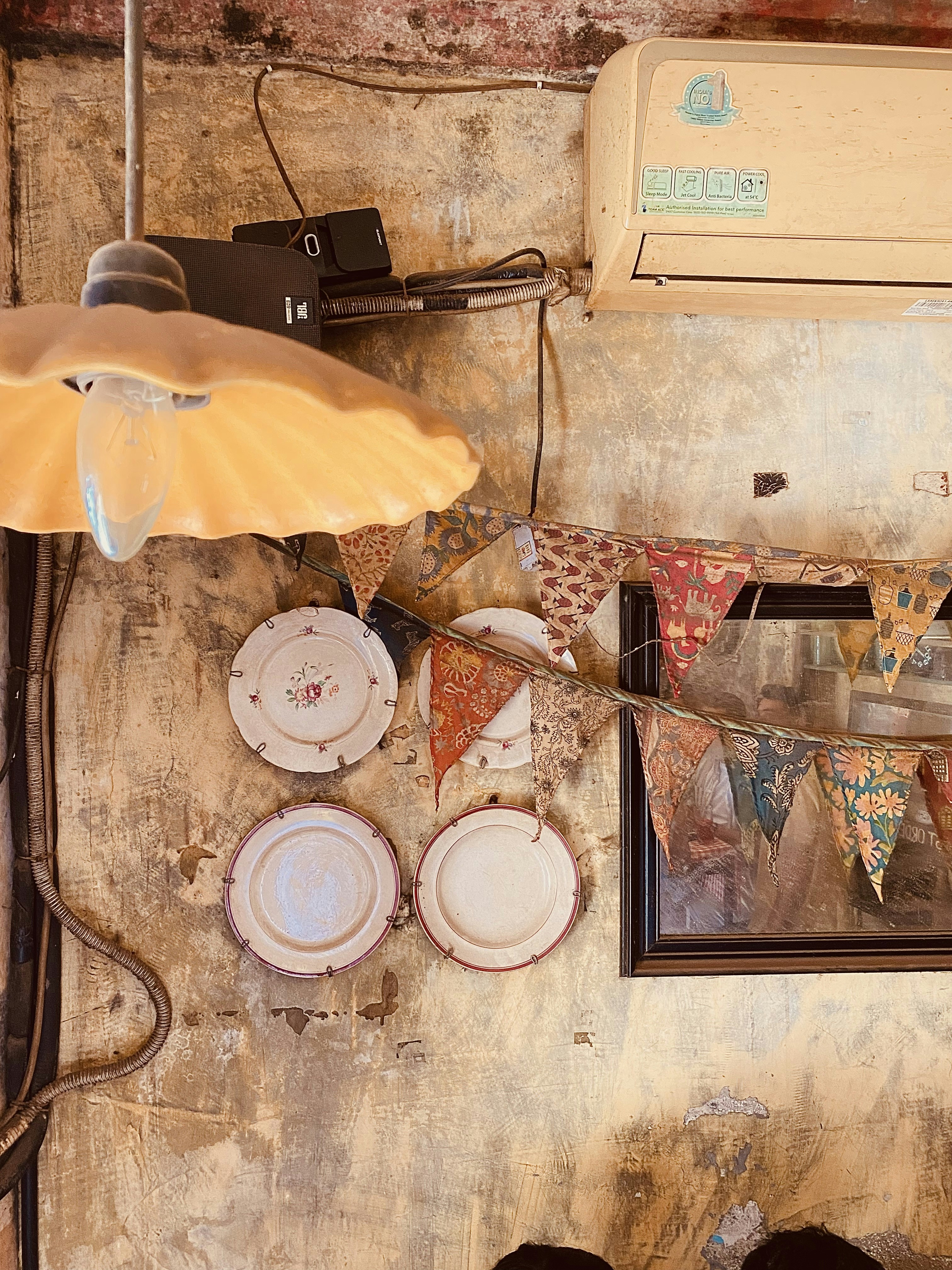 a wall with plates and a lamp on it