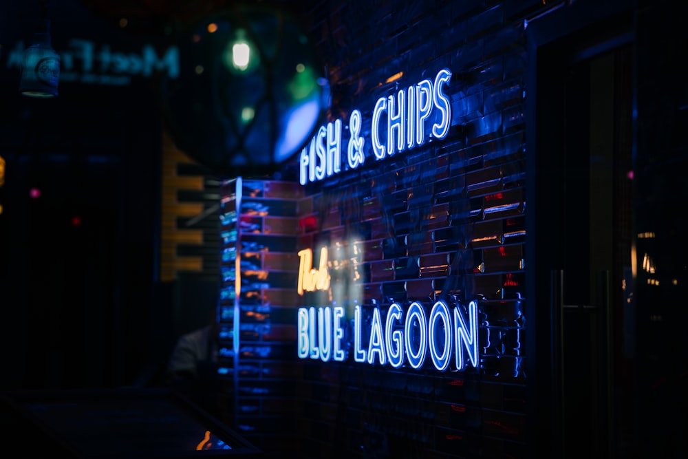 a neon sign that reads fish and chips blue lagoon