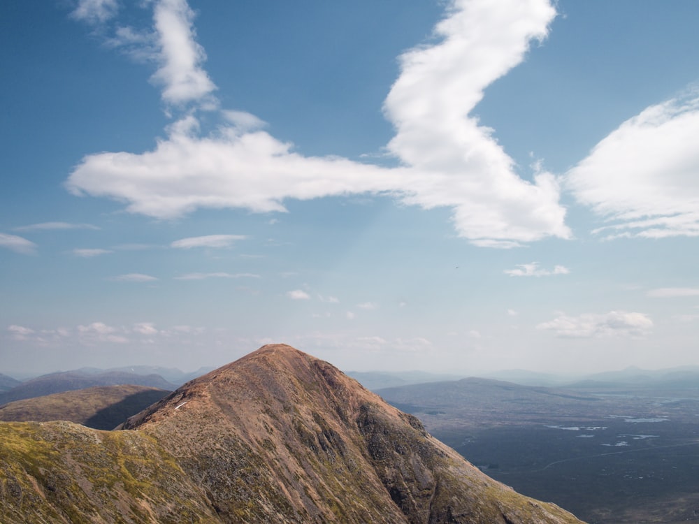 a view of the top of a mountain with a sky background