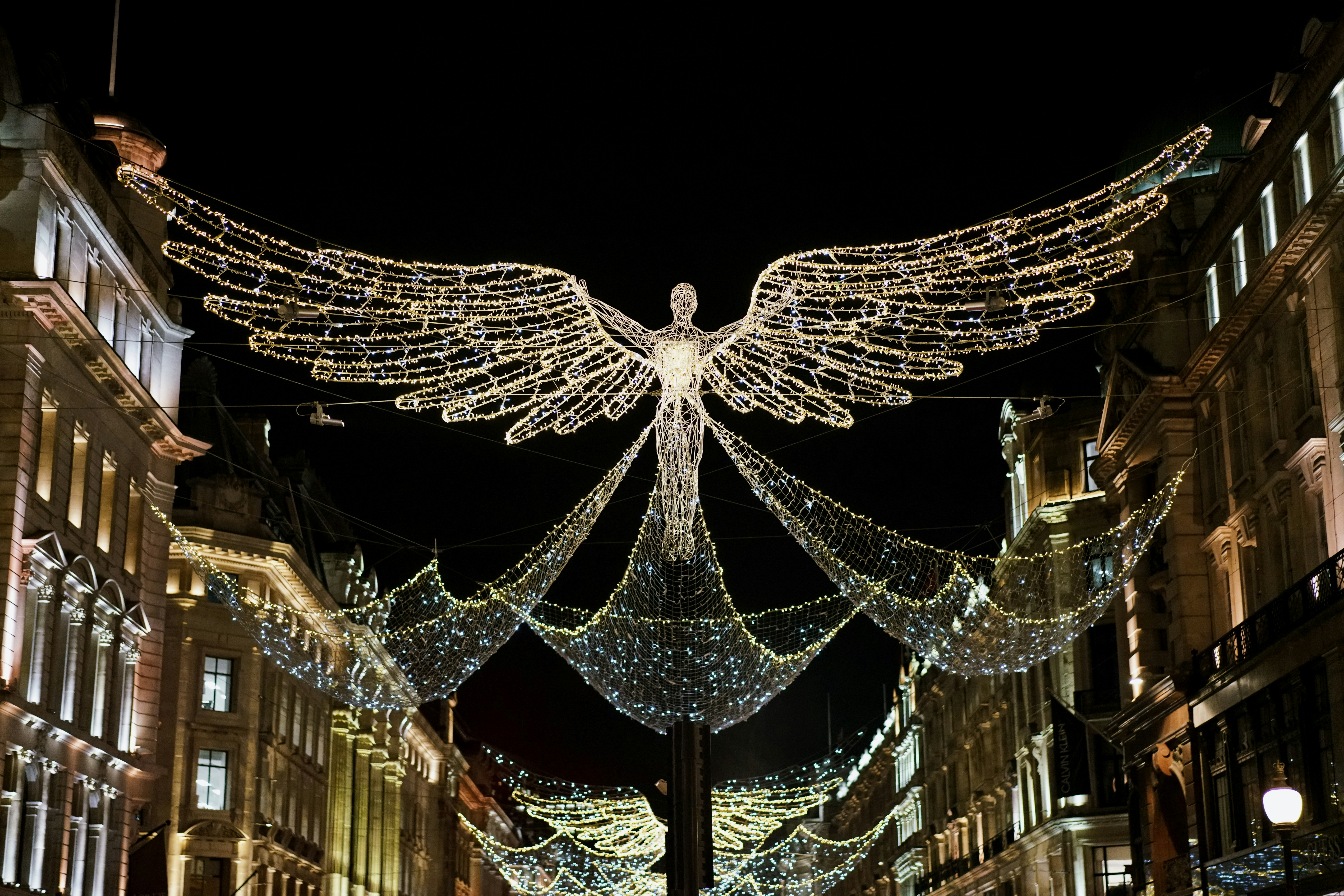 a large angel statue surrounded by christmas lights