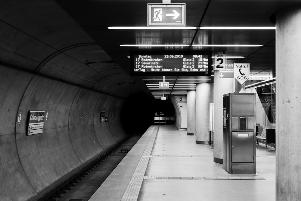 a black and white photo of a subway station