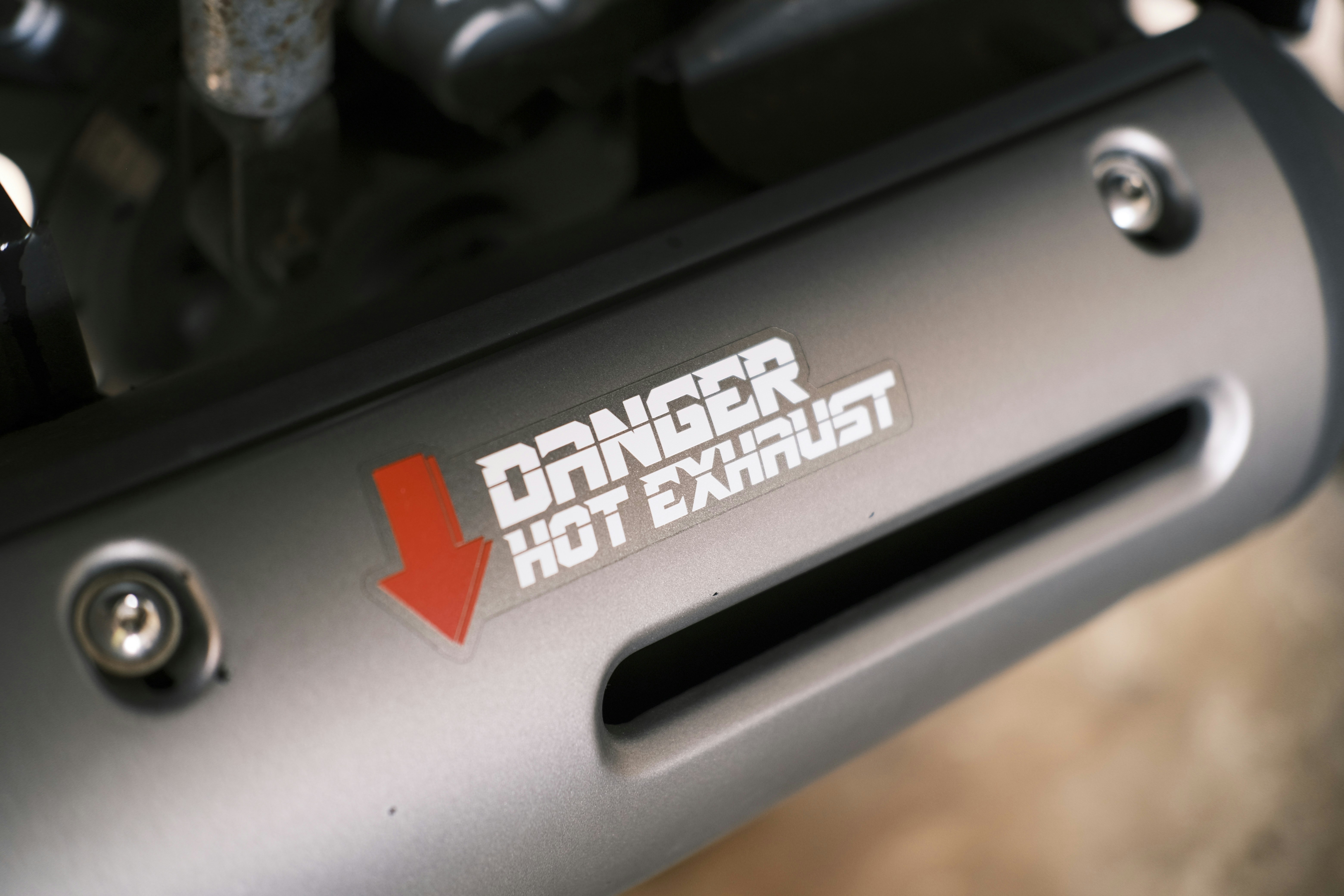 a close up of a metal object with a red arrow