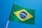the flag of brazil is flying in the blue sky