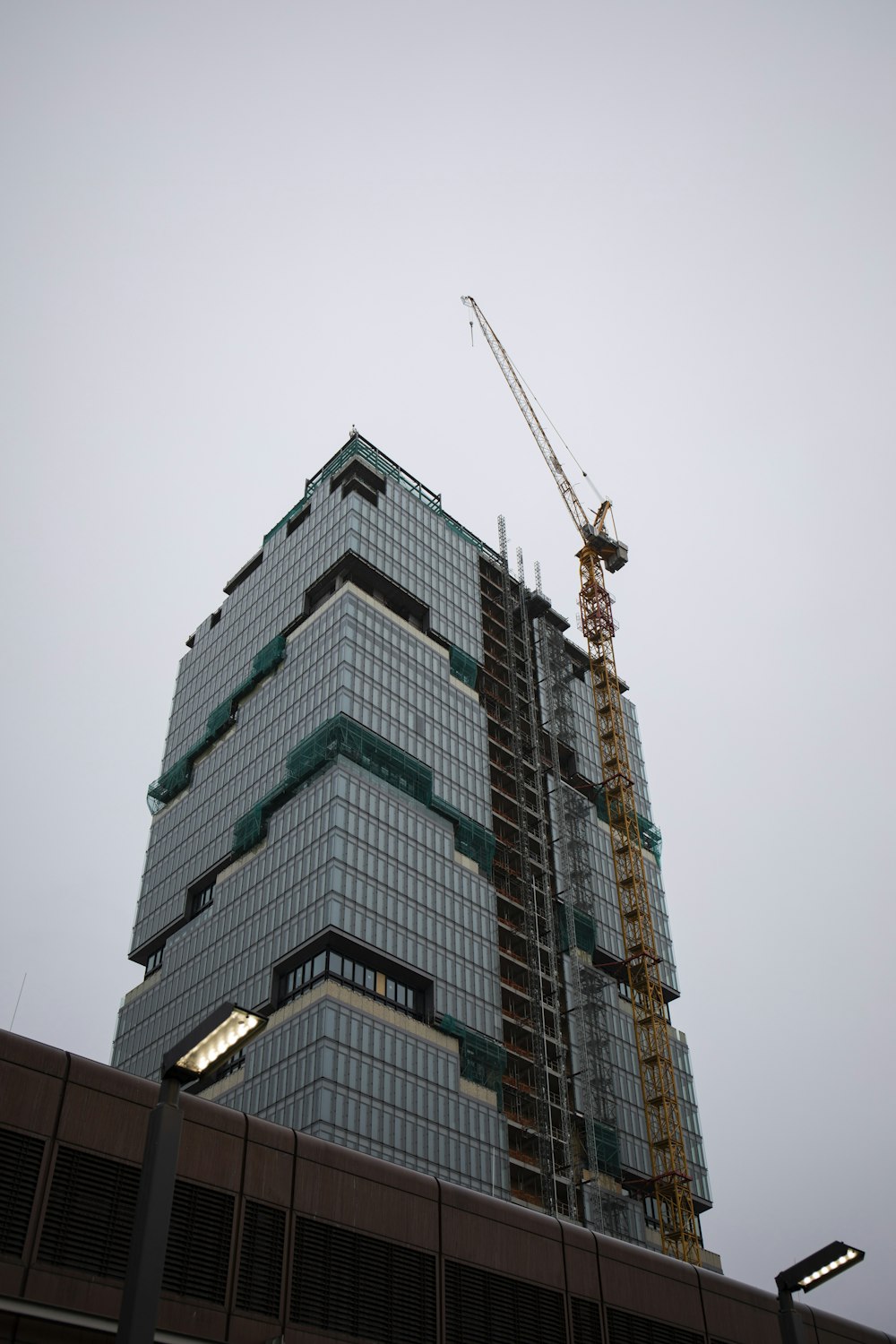 a tall building with a crane on top of it