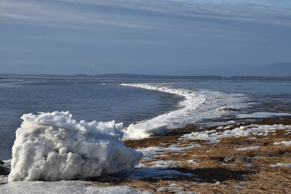 a pile of snow sitting on top of a beach