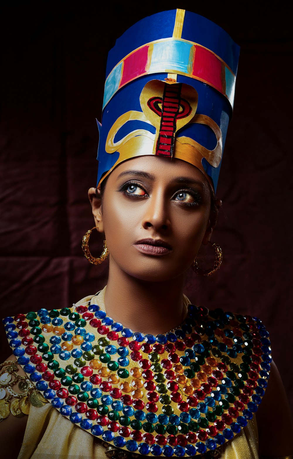 a woman wearing a headdress and a crown