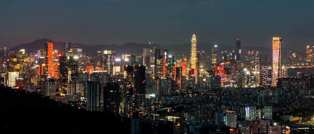 a view of a city at night from the top of a hill