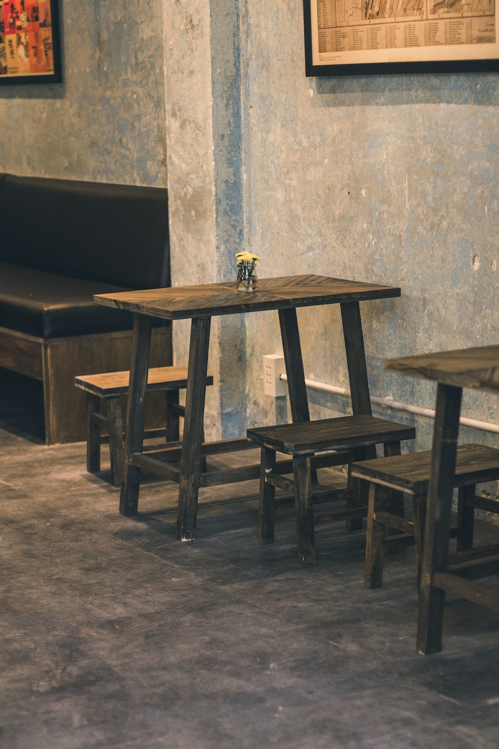 a table and benches in a room with blue walls