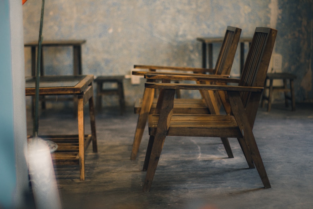 a group of wooden chairs sitting next to each other