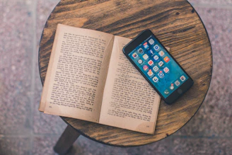 an open book sitting on top of a wooden table