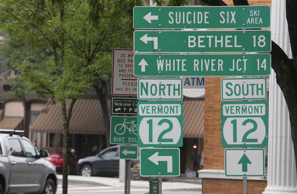 a bunch of street signs that are on a pole