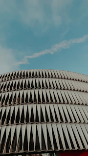 Modern building facade showcasing metal carpentry details under clear sky.