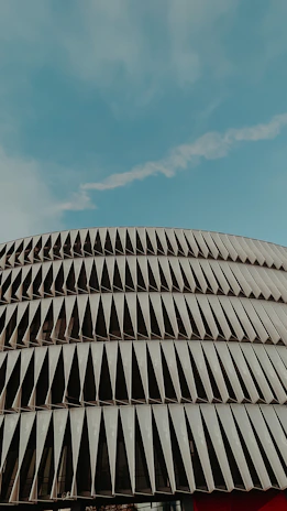 Modern building facade showcasing metal carpentry details under clear sky.