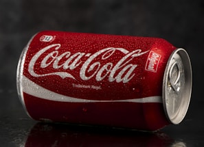 A chilled glass of cola with condensation droplets on the outside.