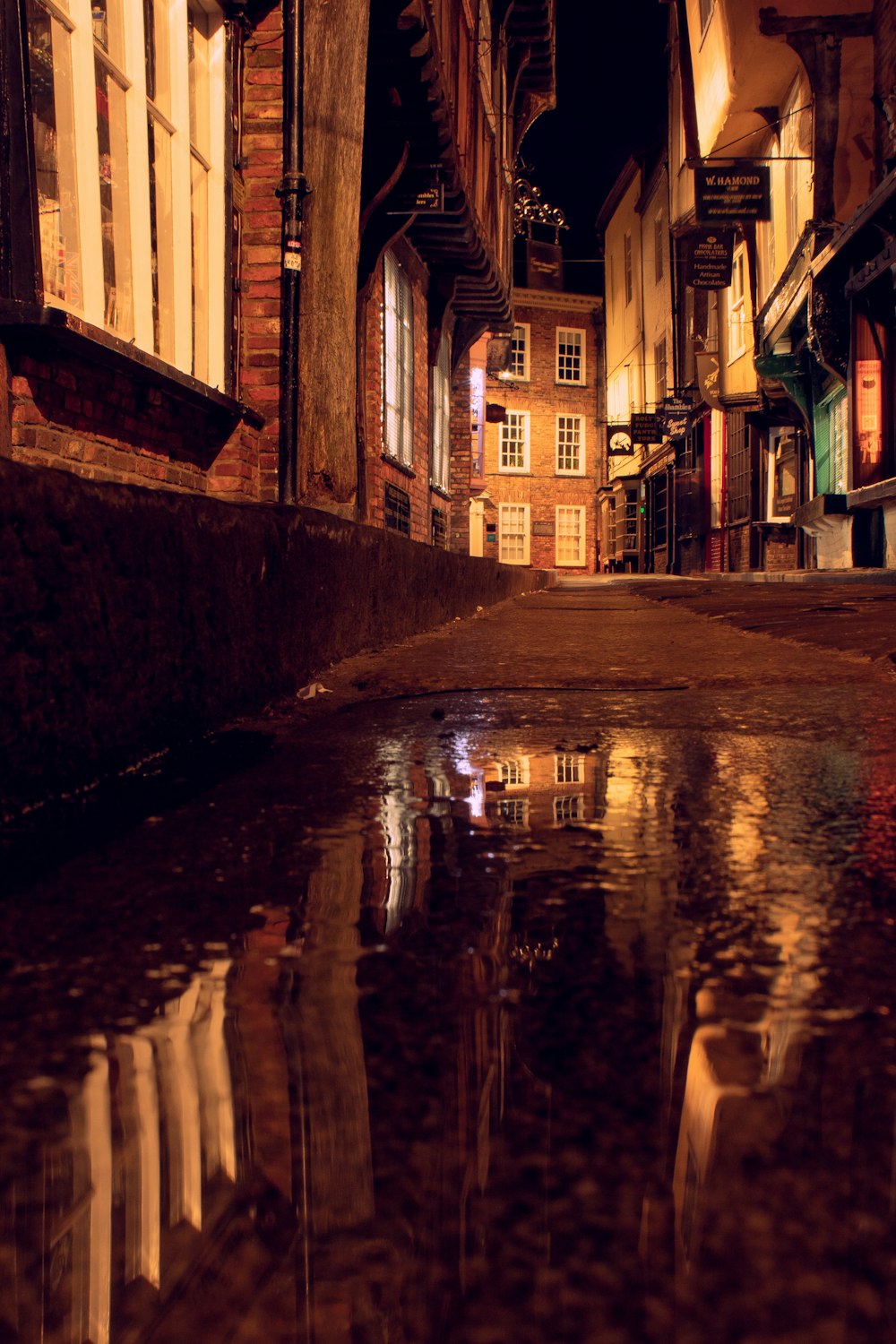 a puddle of water in the middle of a street