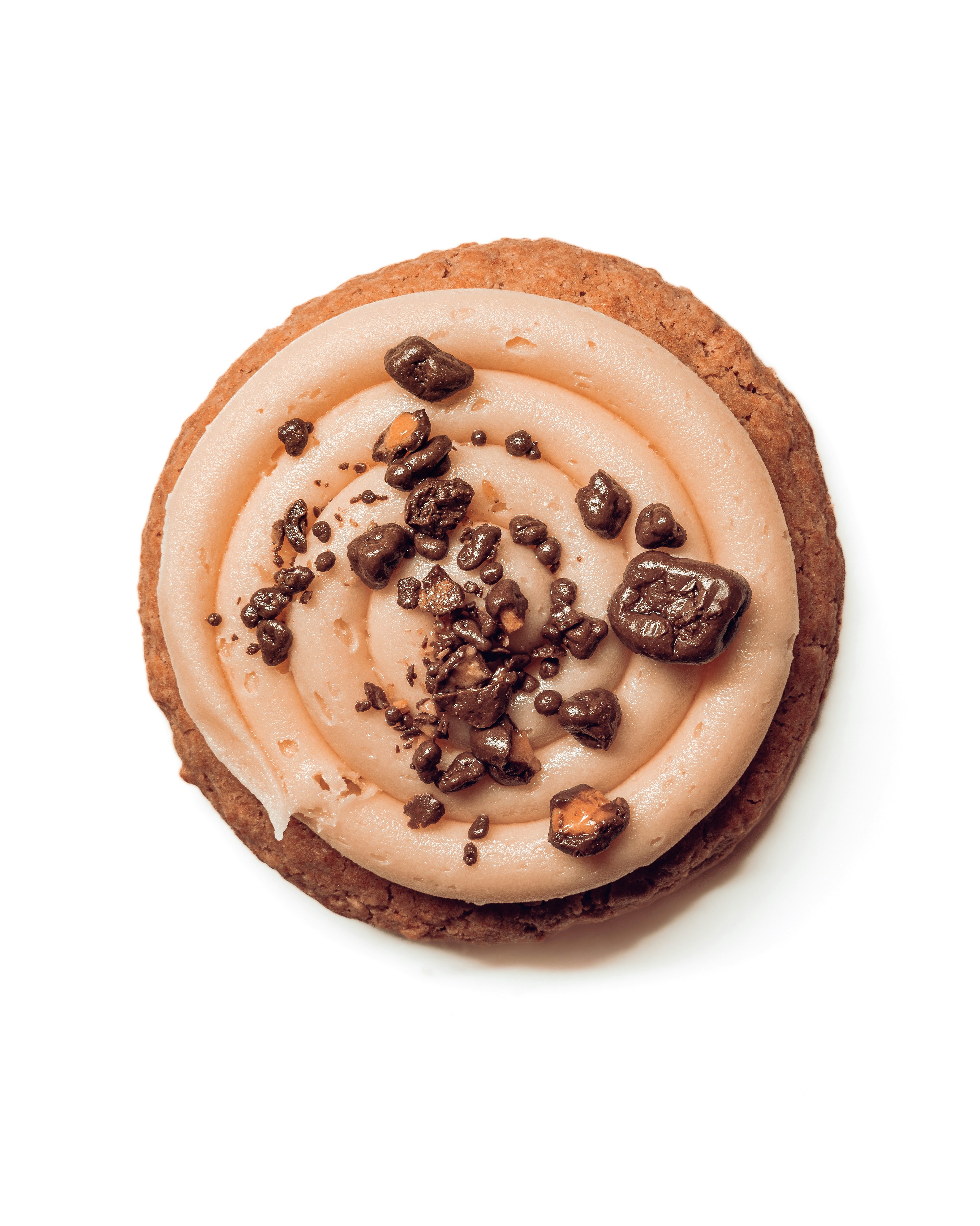 a cookie with white frosting and chocolate chips