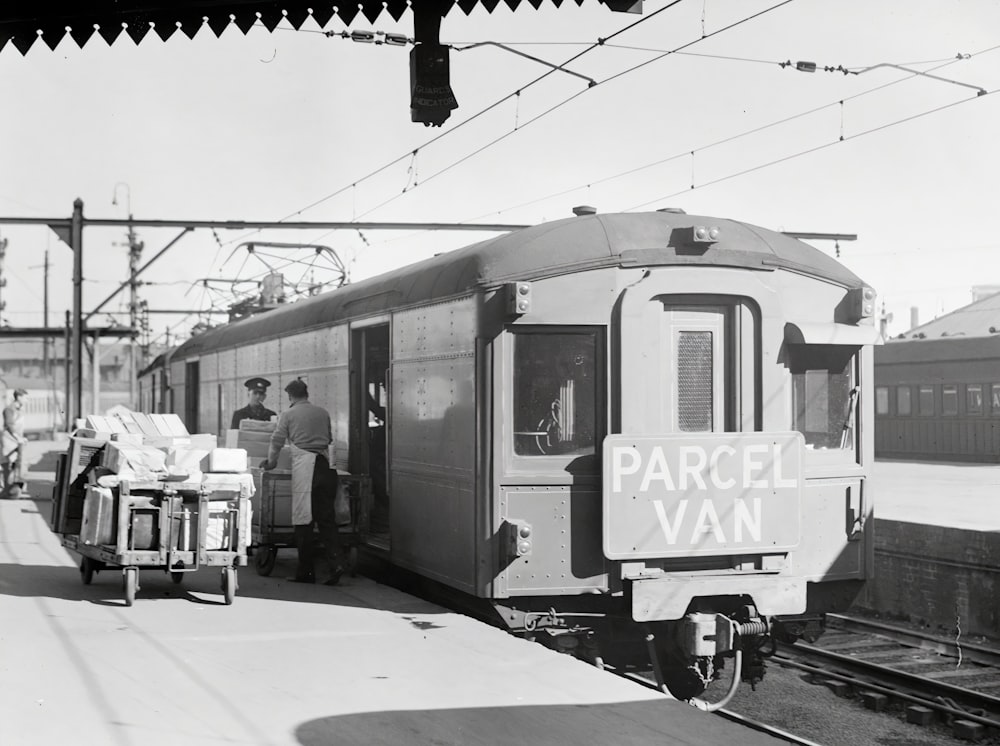 a black and white photo of a train at a station