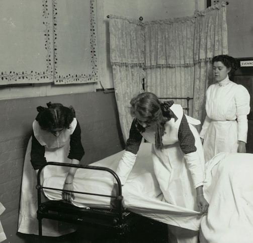 a black and white photo of a woman in a hospital bed