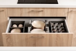 a kitchen drawer with dishes inside of it