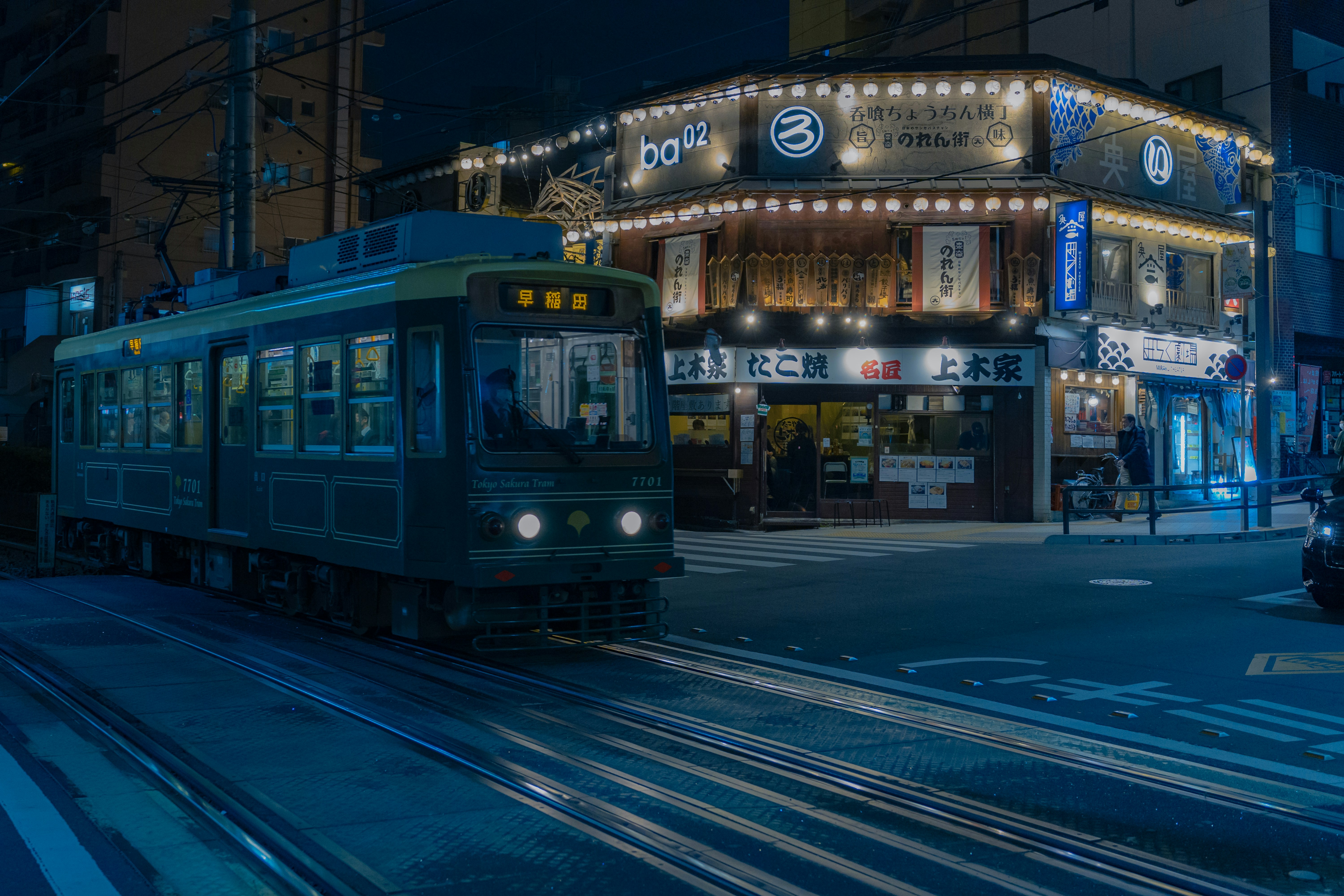 a train on a track in front of a building, 