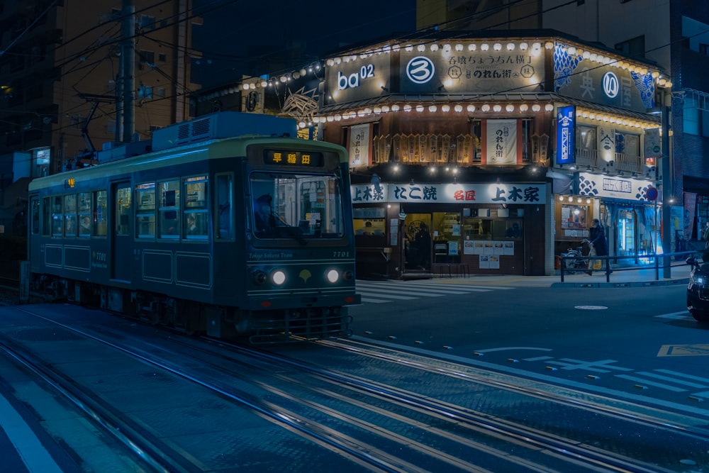 a train on a track in front of a building