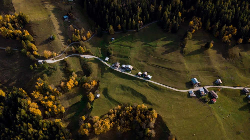 an aerial view of a road winding through a field