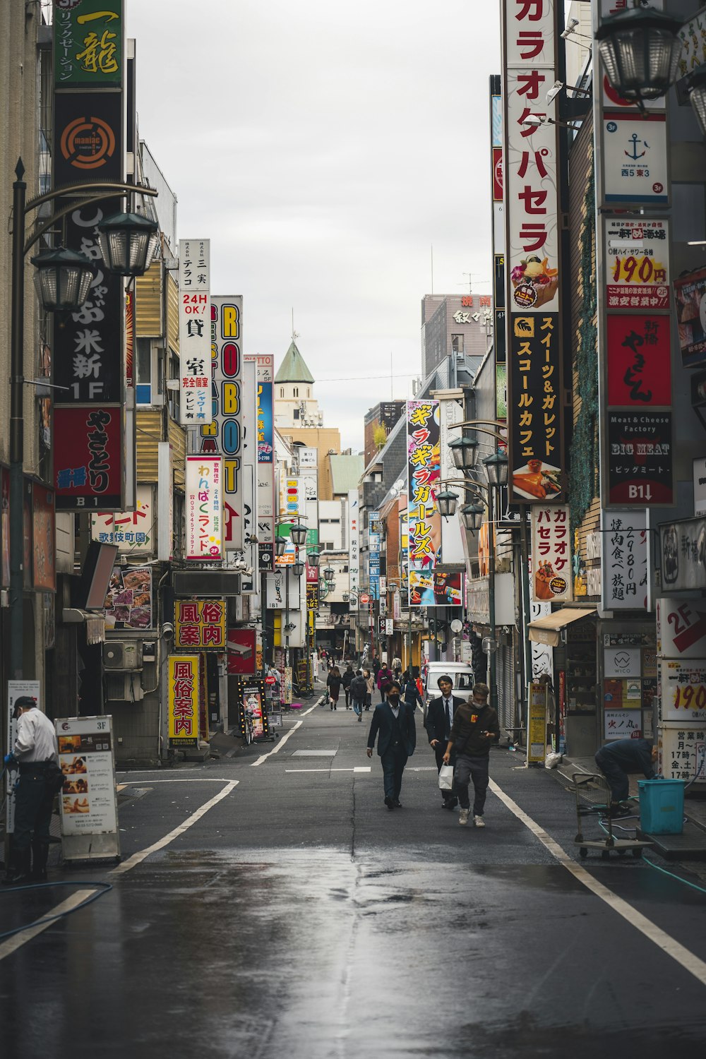 a city street with people walking down it