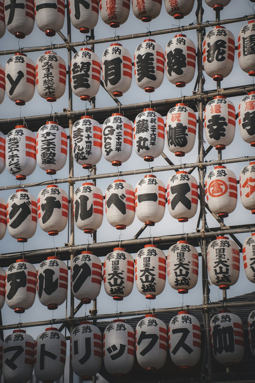 a bunch of asian signs hanging from the side of a building