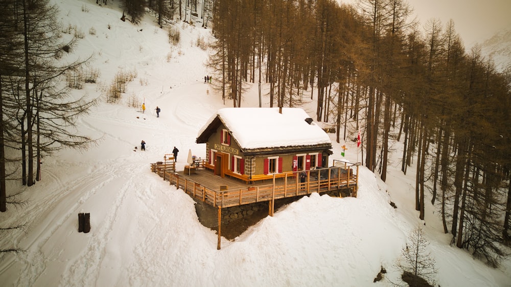 a small cabin in the middle of a snowy forest