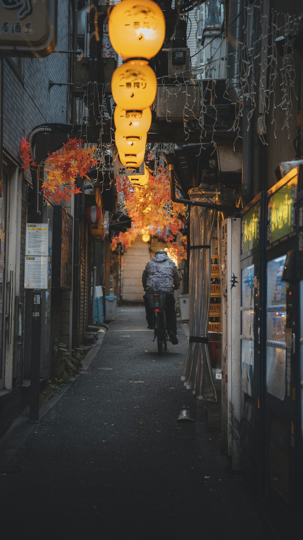 a person riding a bike down a narrow alley way
