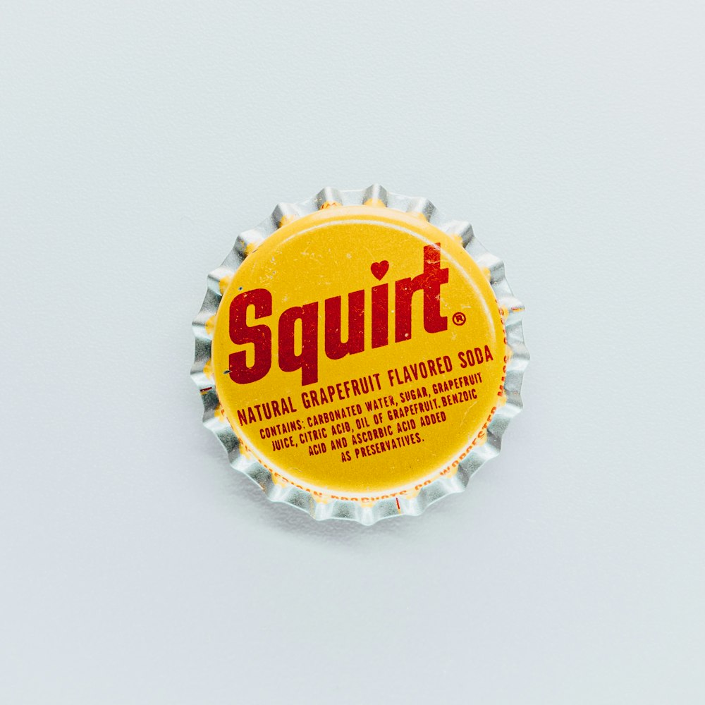a bottle cap with the word squirt on it