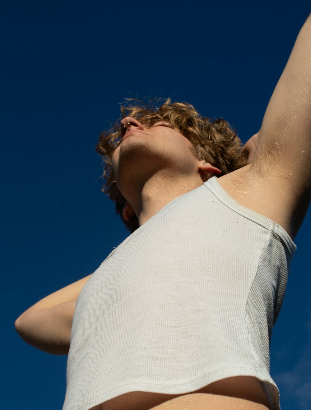 a man flying a kite in a blue sky