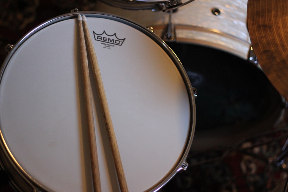 a close up of a drum set with two sticks
