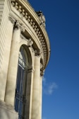 A detailed photograph of classical architectural columns against a clear sky.