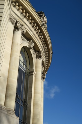 A detailed photograph of classical architectural columns against a clear sky.