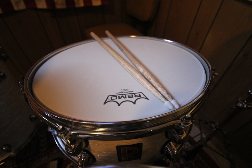 a close up of a drum with two sticks sticking out of it