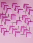 a bunch of pink cubes hanging from a pink wall